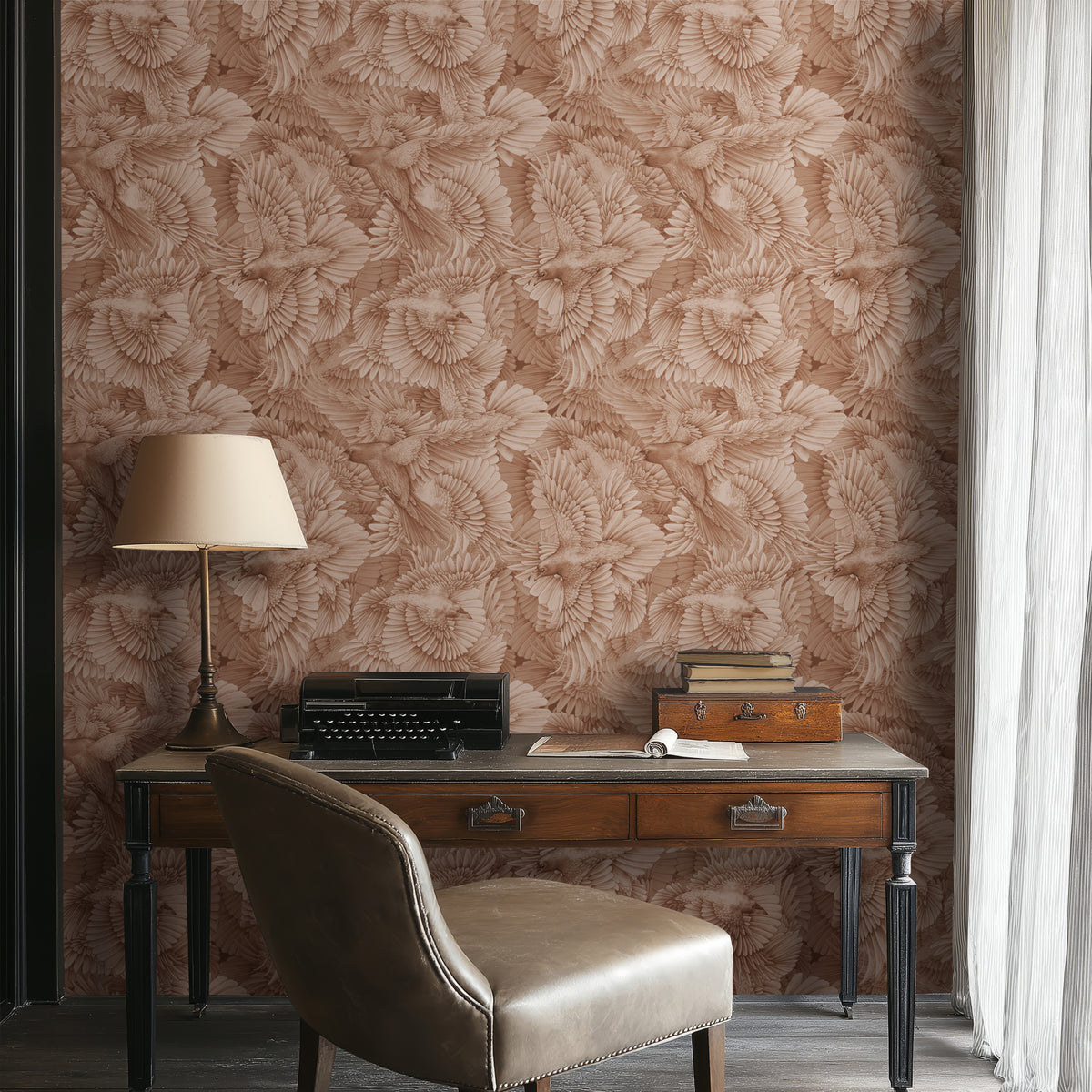 Raven Fleet Quartz wallpaper by Kate Walton: hand-painted ravens in soft blush pink on a home office wall behind a wooden desk
