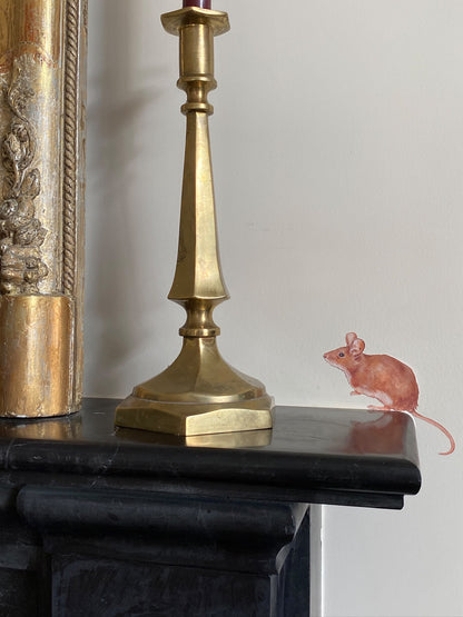 Hand-painted field mouse wall decal on a mantelpiece, a whimsical peel-and-stick touch for a living room or fireplace